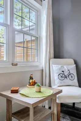 a room with a table and a chair and a window at Sandy Cove Cottage in Crystal Beach