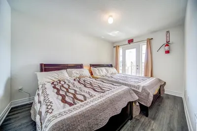 a bedroom with a bed and a window at Executive Town Home-Mountain View-Historic Snowbridge Village, Walking Distance to the Resort in Collingwood