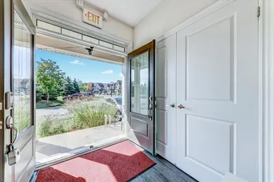 an open door to a balcony with a red rug at Executive Town Home-Mountain View-Historic Snowbridge Village, Walking Distance to the Resort in Collingwood