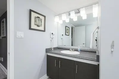 a bathroom with a sink and a mirror at Condo at Blue Mountain on Ski Run Close to Village in Blue Mountains
