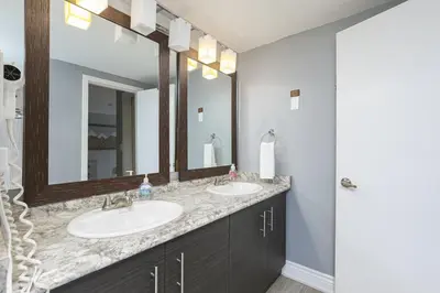 a bathroom with two sinks and a mirror at Condo at Blue Mountain on Ski Run Close to Village in Blue Mountains