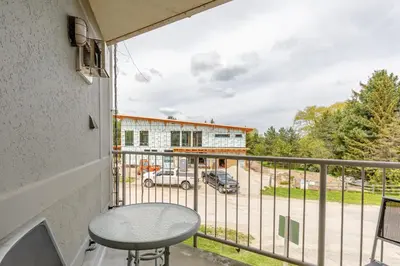 a balcony with a table and a view of a parking lot at Condo at Blue Mountain on Ski Run Close to Village in Blue Mountains