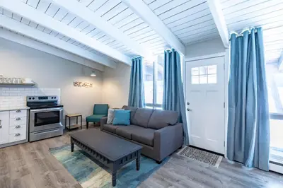 a living room with a couch and a table at Boutique Suite #7 in Blue Mountains