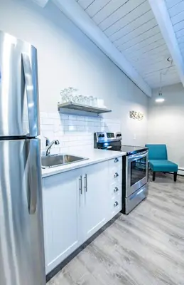 a kitchen with a stainless steel refrigerator and a sink at Boutique Suite #7 in Blue Mountains