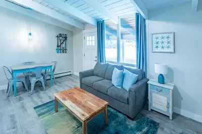 a living room with a couch and a table at Boutique Suite #7 in Blue Mountains