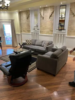 a living room with two couches and a table at Grey Rose Suites in Hanover