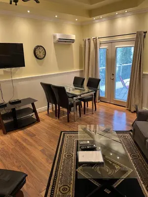 a living room with a table and chairs and a couch at Grey Rose Suites in Hanover