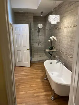 a bathroom with a tub and a sink and a shower at Grey Rose Suites in Hanover
