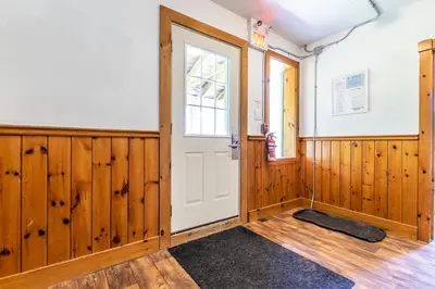a room with wooden paneling and a white door at Mountain Trail-Smart TV-Self Check-In-Full Kitchen-Balcony-BBQ in Blue Mountains