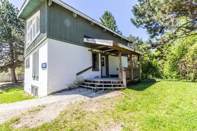 a small white building with a porch on a yard at Mountain Trail-Smart TV-Self Check-In-Full Kitchen-Balcony-BBQ in Blue Mountains