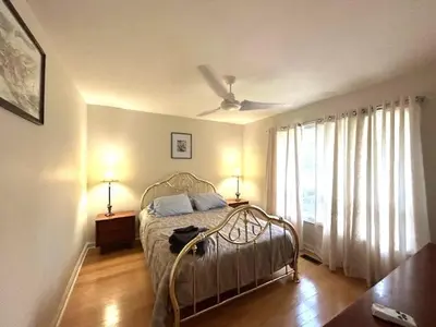 a bedroom with a bed and a ceiling fan at Leslie in Wasaga Beach