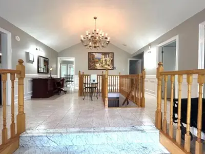 a living room with a chandelier and a dining room at Leslie in Wasaga Beach