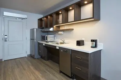 a kitchen with a sink and a refrigerator at TownePlace Suites by Marriott Hamilton in Hamilton