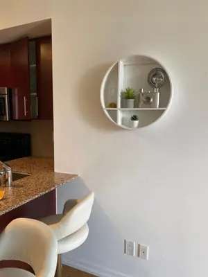 a kitchen with a circular mirror on the wall at Toronto CN Tower Maple Leaf Square Luxurious 2 Bedroom Condo in Toronto