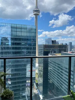 a view of the cn tower from a window at Toronto CN Tower Maple Leaf Square Luxurious 2 Bedroom Condo in Toronto