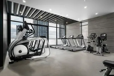 a gym with treadmills and ellipticals in a building at The Laundry Rooms - Waterloo in Waterloo