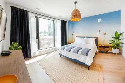a bedroom with a bed and a large window at The Laundry Rooms - Waterloo in Waterloo