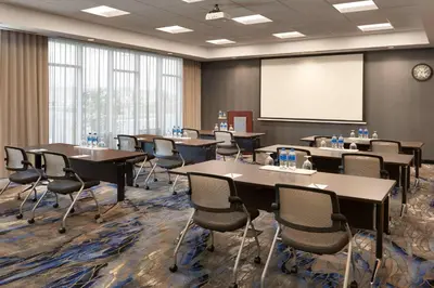 a conference room with tables and chairs and a whiteboard at Fairfield by Marriott Inn & Suites Orillia in Orillia
