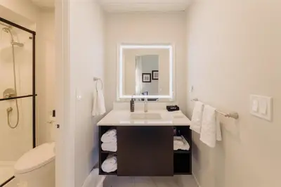 a bathroom with a sink and a mirror and a toilet at Mercer Hotel Downtown; BW Premier Collection in Stratford