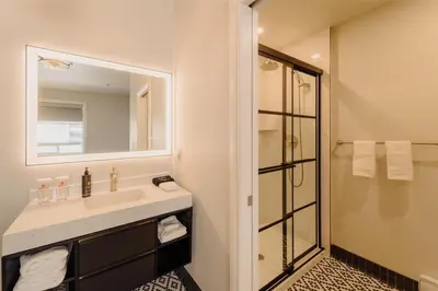 a bathroom with a sink and a shower at Mercer Hotel Downtown; BW Premier Collection in Stratford