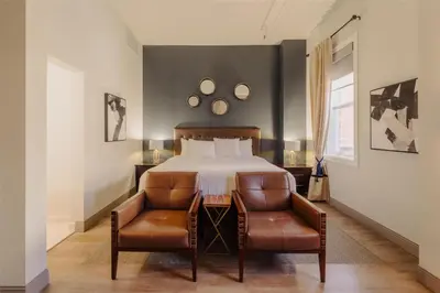 a bedroom with a bed and a table and chairs at Mercer Hotel Downtown; BW Premier Collection in Stratford