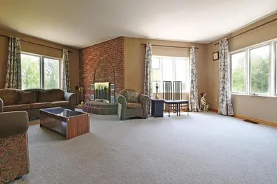 a living room with couches and a brick wall at Grand Villa Estate in Burlington