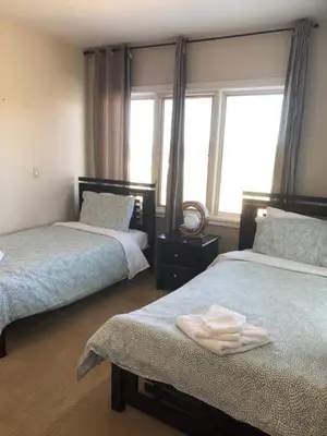 a bedroom with two beds and a window at Grand Villa Estate in Burlington