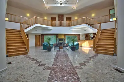 a large lobby with a staircase and a living room at Grand Villa Estate in Burlington