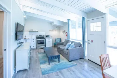 a living room with a couch and a kitchen at 2BR Boutique Suite #8 in Blue Mountains