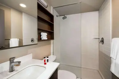 a bathroom with a sink and a toilet and a shower at Microtel Inn & Suites by Wyndham Aurora in Aurora