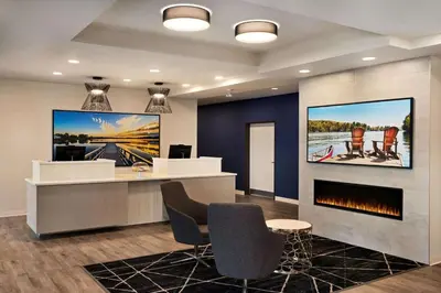 a lobby with a reception desk and a fireplace at Microtel Inn & Suites by Wyndham Aurora in Aurora