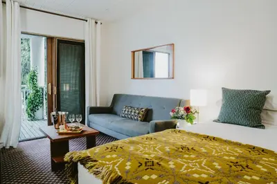 a hotel room with a bed and a couch at The Kent Motel in Niagara on the Lake