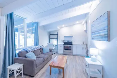 a living room with a couch and a table at Boutique Suite #3 in Blue Mountains