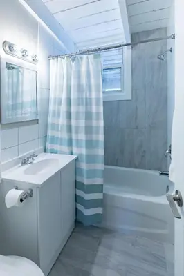 a white bathroom with a sink and a shower at Boutique Suite #5 in Blue Mountains