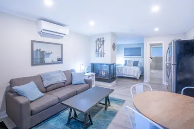 a living room with a couch and a table at Boutique Suite #2 in Blue Mountains