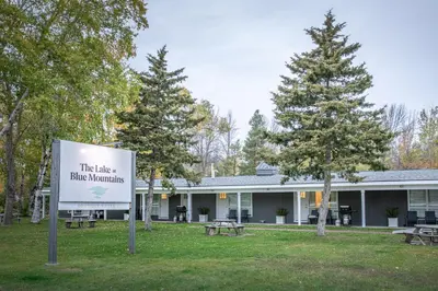a sign in front of a building with trees and benches at Boutique Suite #2 in Blue Mountains