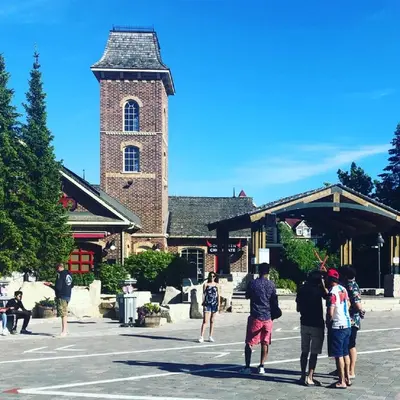 a group of people standing outside of a building with a tower at Boutique Suite #2 in Blue Mountains