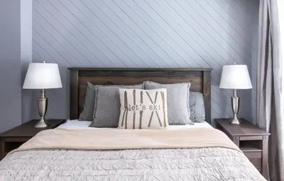 a bedroom with a bed with two lamps at 4 Bedroom Rustic Chalet in Blue Mountains