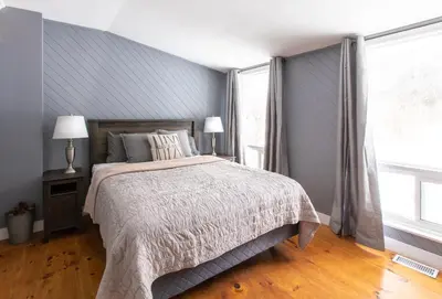 a bedroom with a bed and a large window at 4 Bedroom Rustic Chalet in Blue Mountains