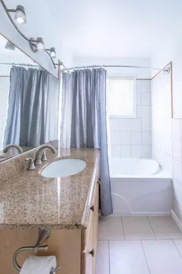 a bathroom with a sink and a bath tub at 4 Bedroom Rustic Chalet in Blue Mountains