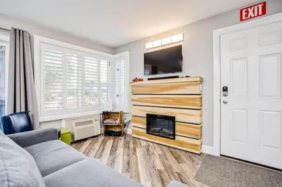a living room with a couch and a fireplace at Luxury Studio Getaway at Blue Mountains 80114 in Blue Mountains