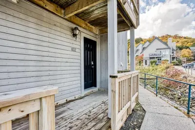 a front porch of a house with a black door at Luxury Studio Getaway at Blue Mountains 80114 in Blue Mountains