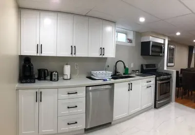 a kitchen with white cabinets and a counter top at 3 Spacious Bedroom Basement Apartment in Richmond Hill in Richmond Hill