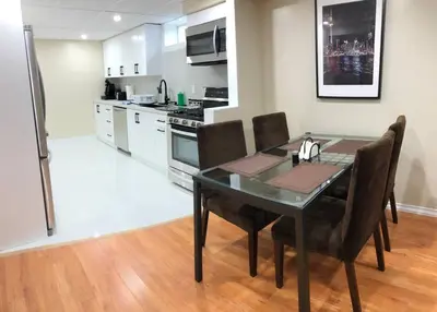a dining room table and chairs in a kitchen at 3 Spacious Bedroom Basement Apartment in Richmond Hill in Richmond Hill