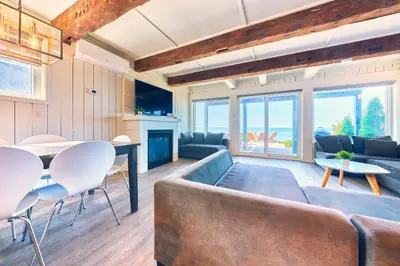 a living room with a couch and a table at The Long Beach Resort - Beachfront Cottages & Townhouse Suites in Wainfleet