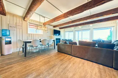 a living room with a couch and a table at The Long Beach Resort - Beachfront Cottages & Townhouse Suites in Wainfleet