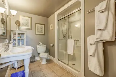 a bathroom with a shower and a sink and a toilet at School House Bed and Breakfast C.1859 in Niagara on the Lake