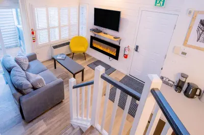 a living room with a couch and a fire place at Loft with a view of Blue - Free Wifi, Linens and Towels Included in Blue Mountains