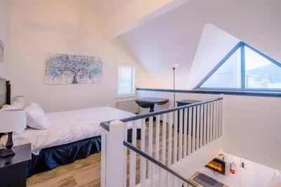 a small bedroom with a bed and a window at Loft with a view of Blue - Free Wifi, Linens and Towels Included in Blue Mountains