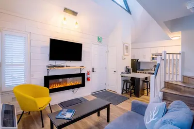 a living room with a fireplace and a tv at Loft with a view of Blue - Free Wifi, Linens and Towels Included in Blue Mountains
